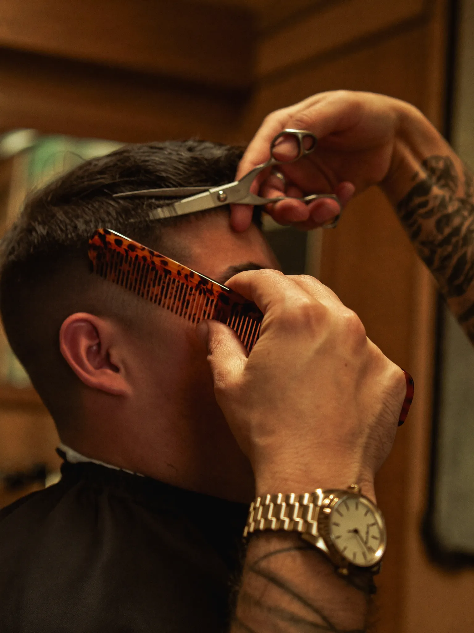 Barber at work with comb and scissors